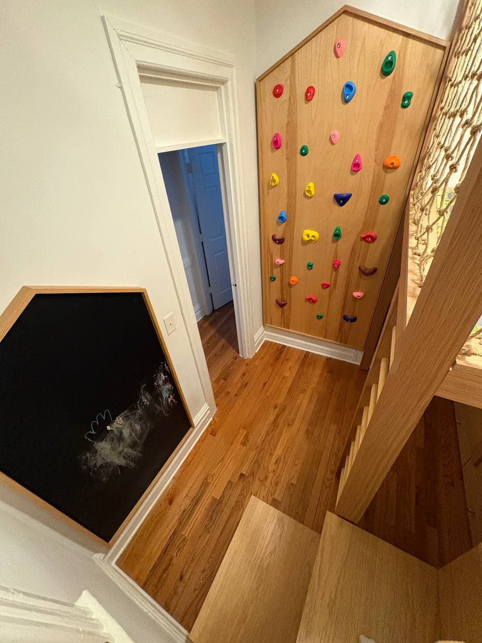 hallway climbing wall with house-shaped chalkboard