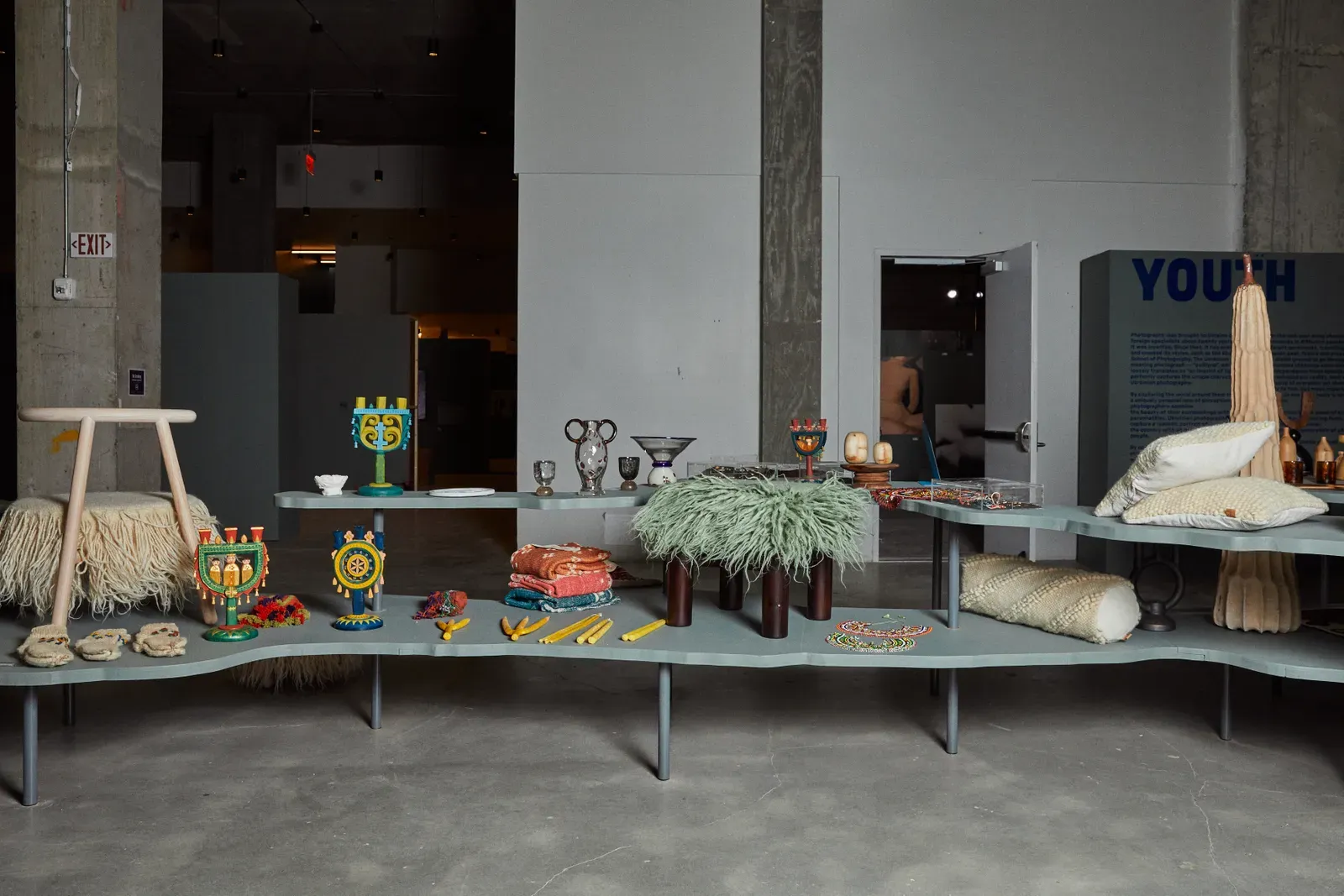 artisan objects on long wavy grey display shelf