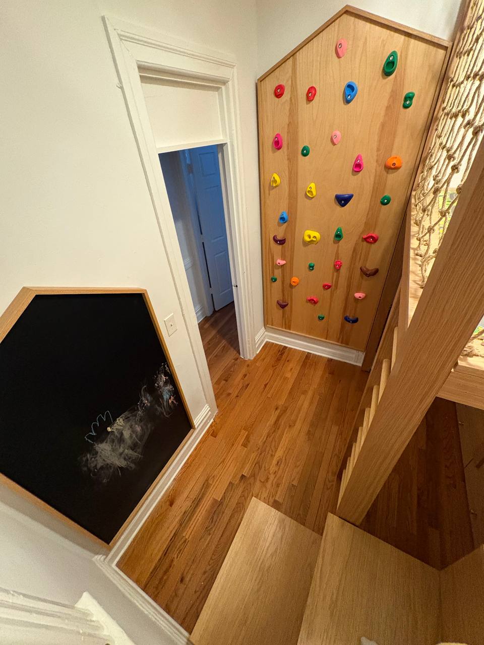 hallway climbing wall with house-shaped chalkboard