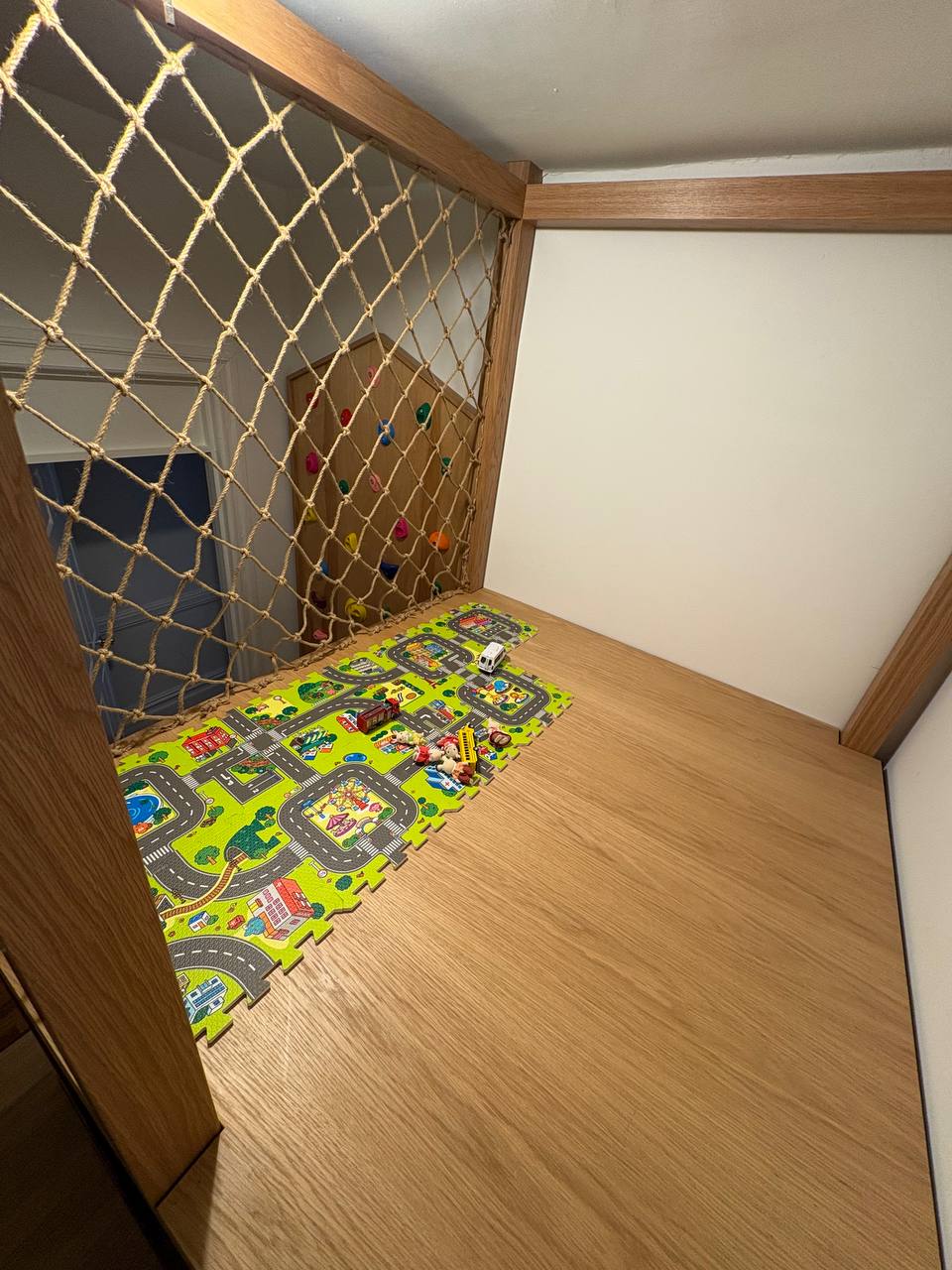 elevated play loft with rope netting and toy cars